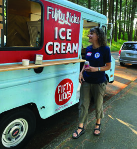 PROTEC17 member pictured standing in front of the Fifty Licks Ice Cream Truck.