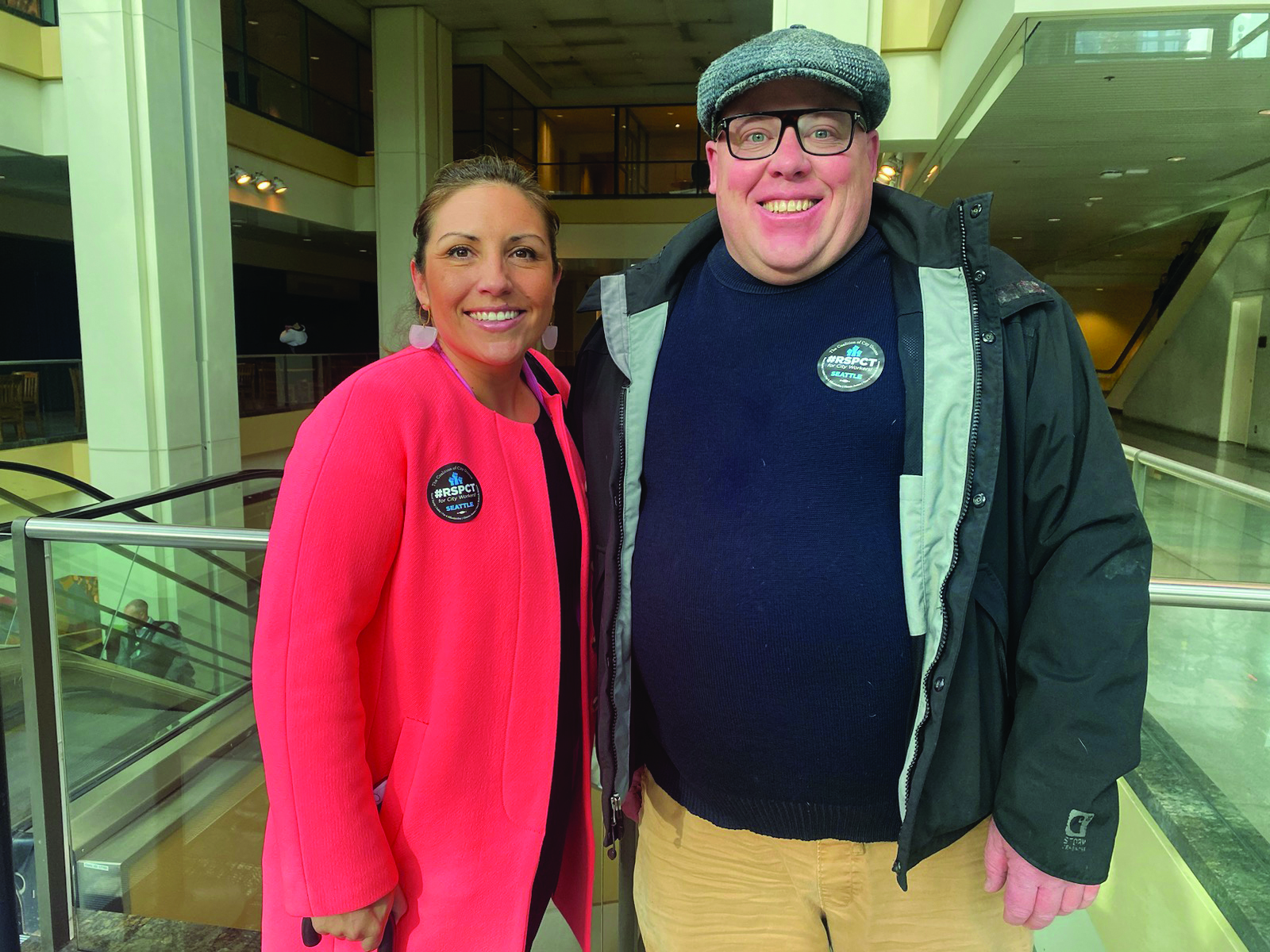 Jamie Fackler, Seattle Steward and member of the Contract Action Team, poses with Seattle City Councilmember Teresa Mosqueda wearing their #RSPCTforCityWorkers stickers.