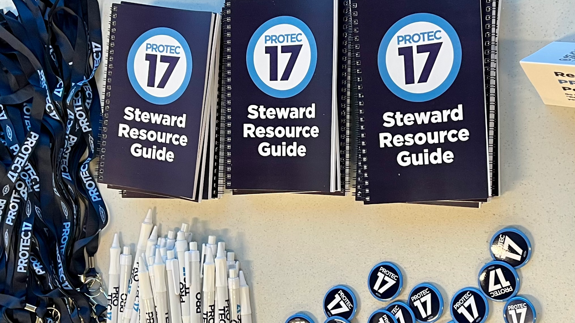 Picture of the new PROTEC17 Steward Guides alongside PROTEC17 lanyards and pins.