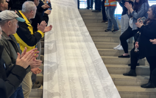 Picture of Seattle RSPCT petition scroll, cascading down the stairs at Seattle City Hall.