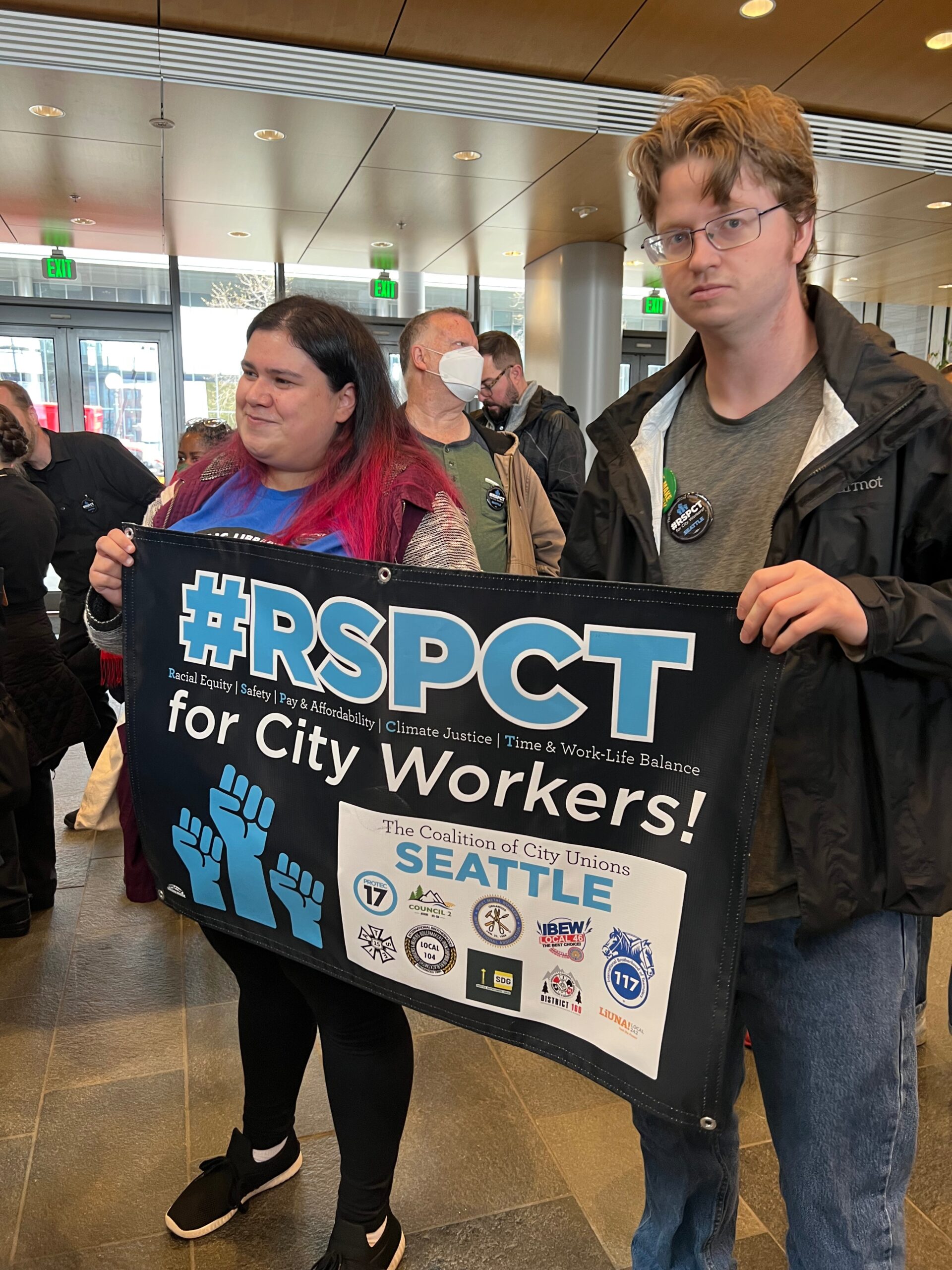 Picture of PROTEC17 Seattle members holding the RSPCT campaign banner.