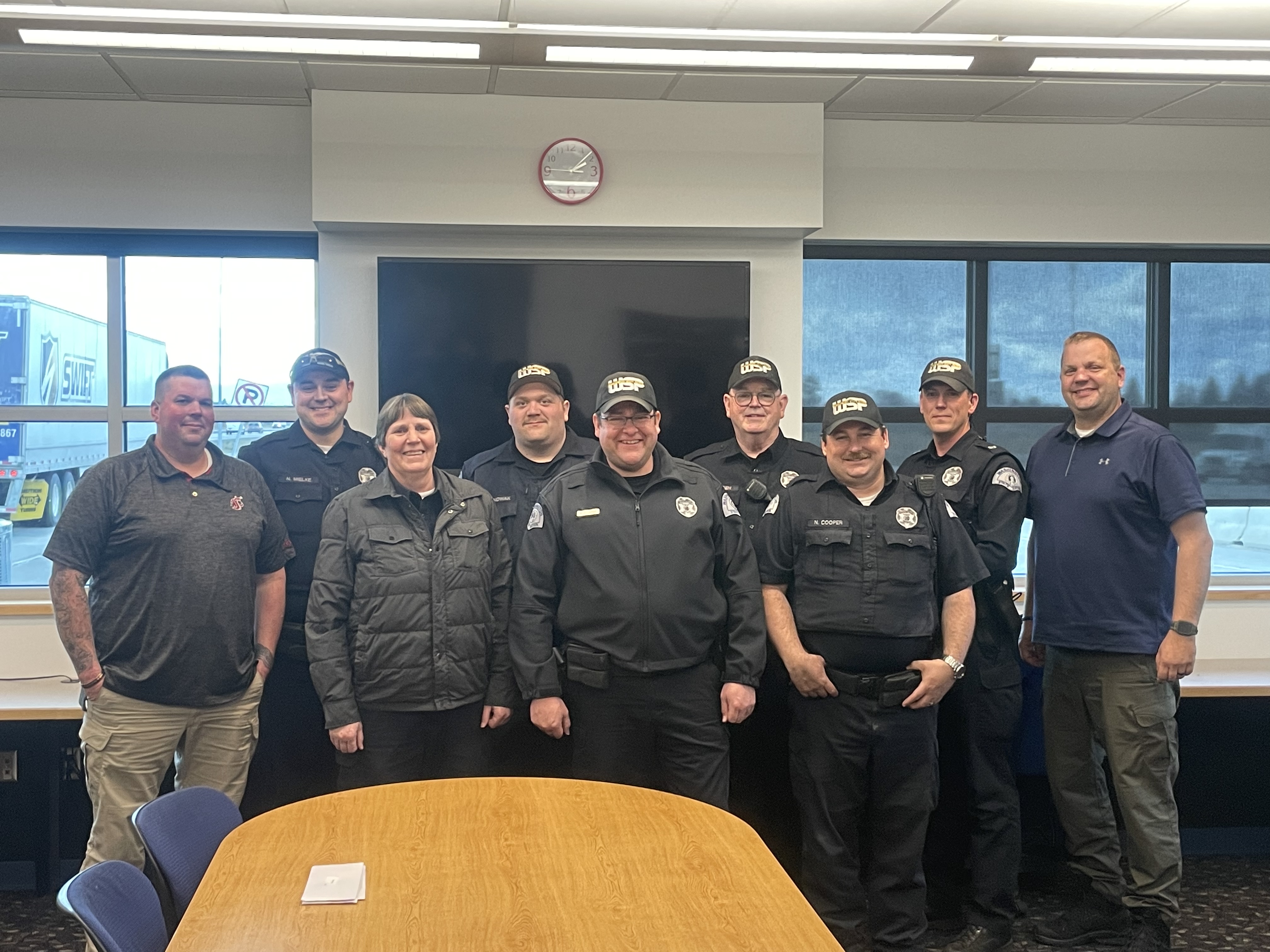Picture of Washington State Patrol CVEO's, including PROTEC17 Chapter Officer Bennet Olsson. They are wearing their uniforms and smiling in together.