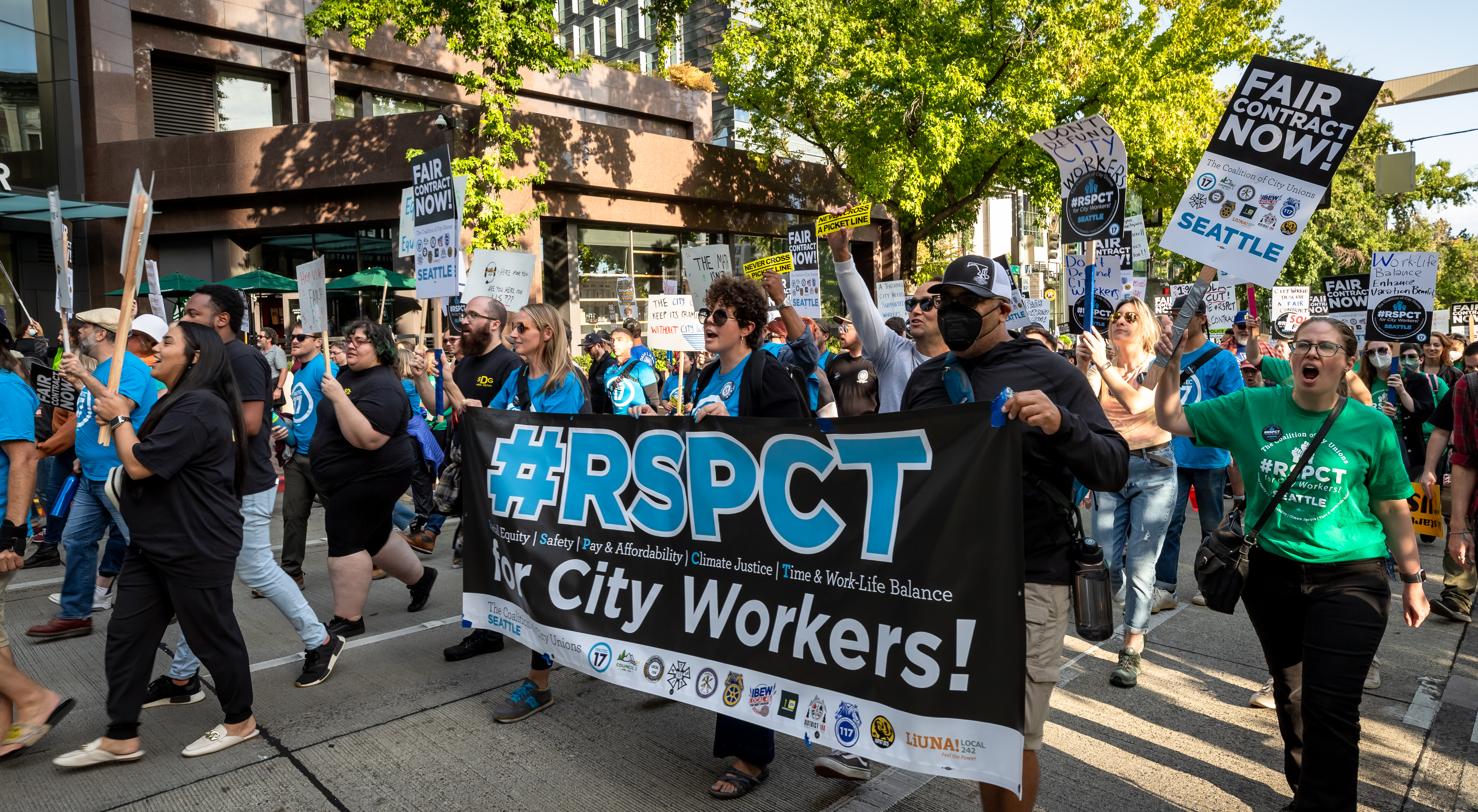 Picture of PROTEC17 staff and members marching with other Coalition of City Union members and staff, holding up our #RSPCT for City Workers banner.
