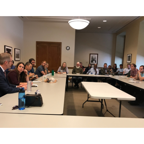 People are sitting around large conference tables for a Labor Committee Meeting (LMC).